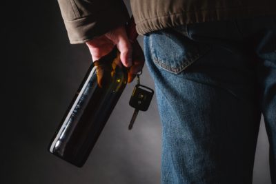 Man holding bear and car keys in one hand 