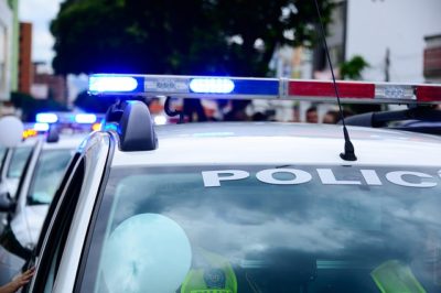 Row of police vehicles with lights on